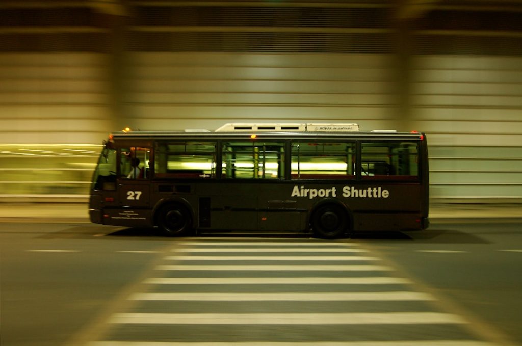 red-and-black-bus-on-gray-road-ifs-bfxjdj8